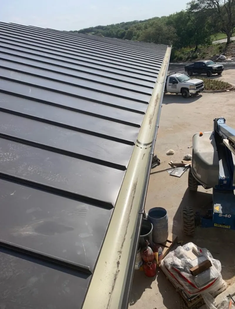 Standing seam panel and gutter detail on a metal roofing jobsite in Poplar Bluff